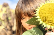 shy_girl_behind_sunflower.jpg